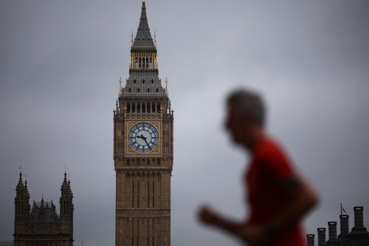 Blurry man running past the Houses of Parliament with big ben in the background